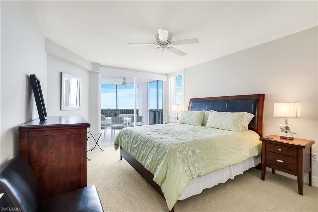 Bedroom featuring light carpet, access to exterior, and ceiling fan