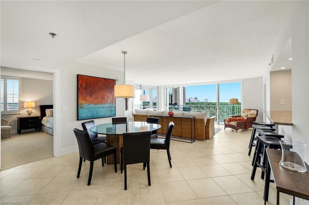 Dining room featuring a view of skyline, recessed lighting, and expansive windows