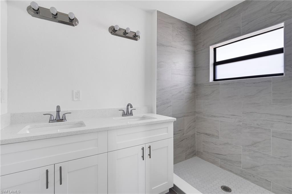 Bathroom with double vanity and a shower stall
