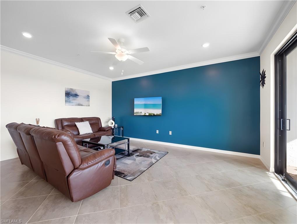 Living area featuring ceiling fan, ornamental molding, and recessed lighting