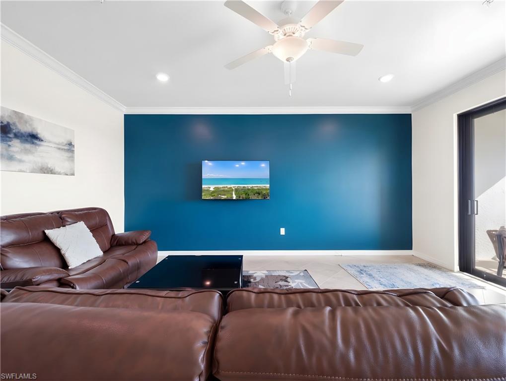 Tiled living room with crown molding, a ceiling fan, and recessed lighting