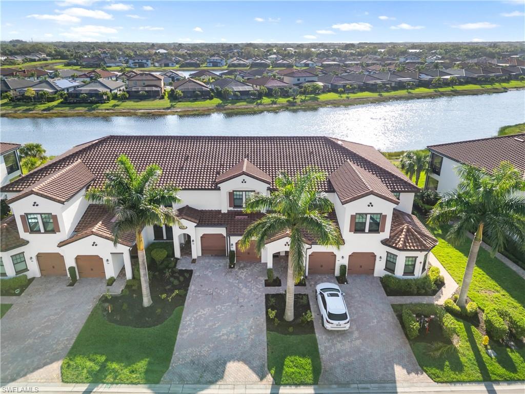 Aerial perspective of suburban area featuring a nearby body of water