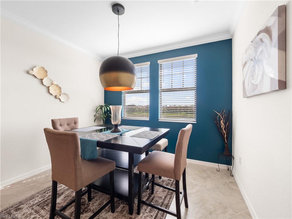 Dining space featuring crown molding and baseboards