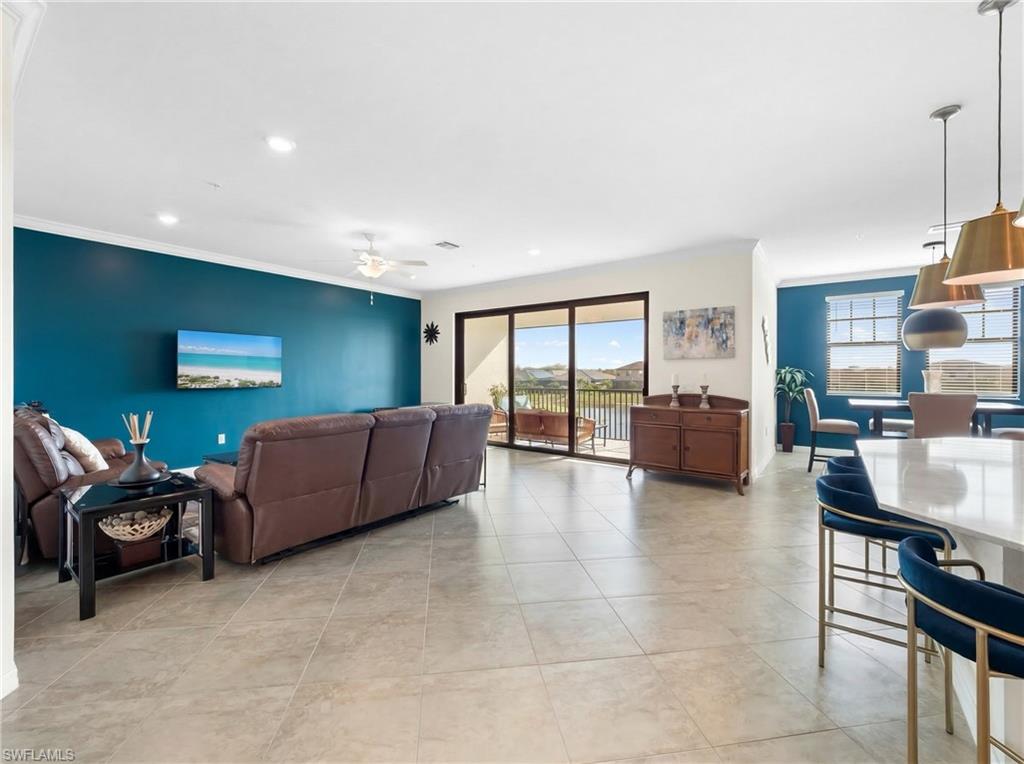 Living area with ceiling fan, light tile patterned floors, and recessed lighting
