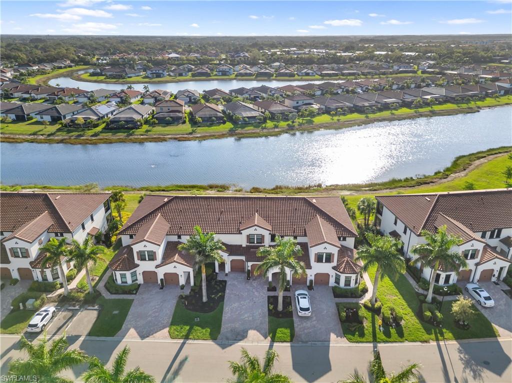 Aerial perspective of suburban area featuring a nearby body of water
