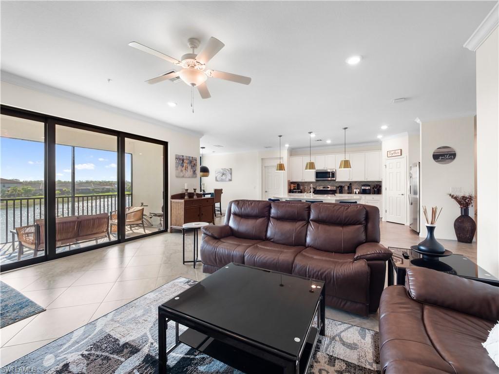 Living room with crown molding, ceiling fan, and recessed lighting