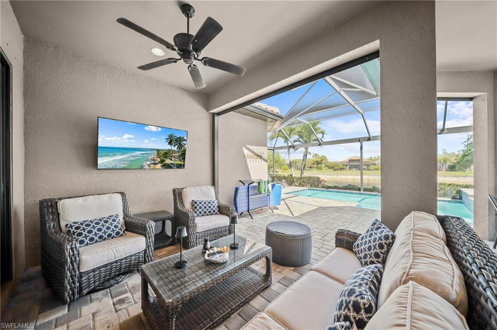 View of patio / terrace featuring an outdoor hangout area, an outdoor pool, a sunroom, and glass enclosure