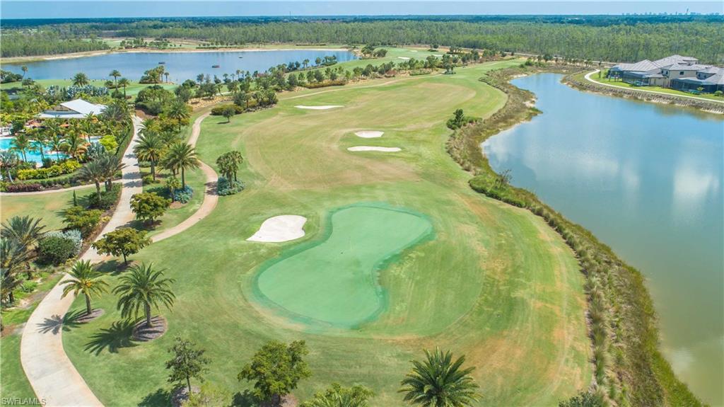 Drone / aerial view of a nearby body of water and a golf club
