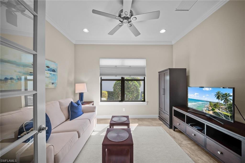 Living room with a ceiling fan, crown molding, and recessed lighting