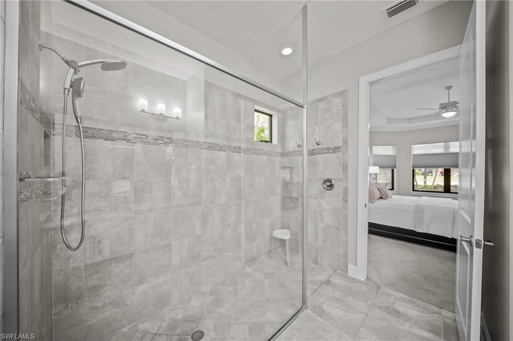 Full bathroom with connected bathroom, a tile shower, ceiling fan, and recessed lighting