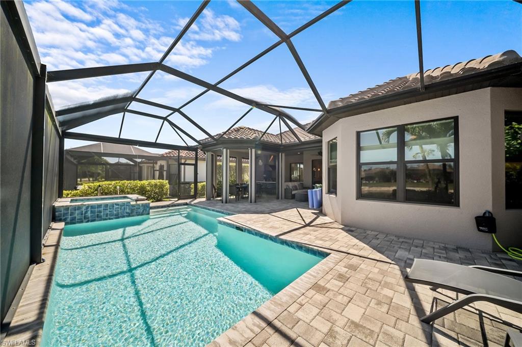 Integrated pool / spa featuring a patio area, a sunroom, and a lanai