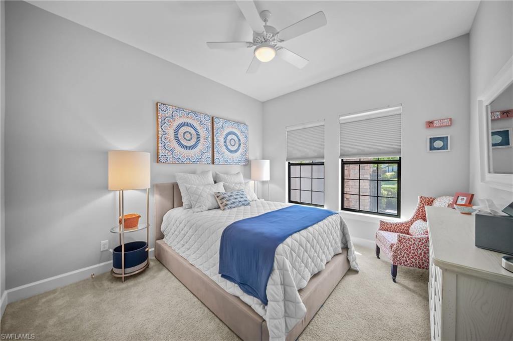 Bedroom with a ceiling fan and light carpet