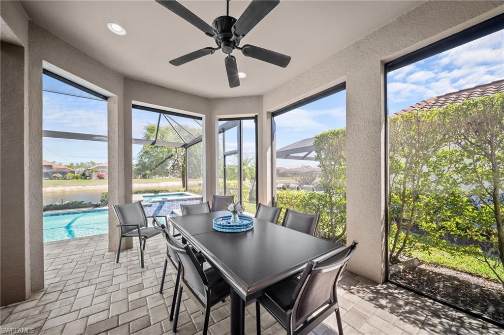 Sunroom with a patio area, a ceiling fan, a pool, and outdoor dining area