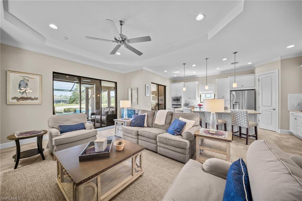 Living area with crown molding, ceiling fan, and recessed lighting