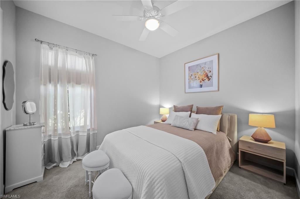Carpeted bedroom featuring a ceiling fan
