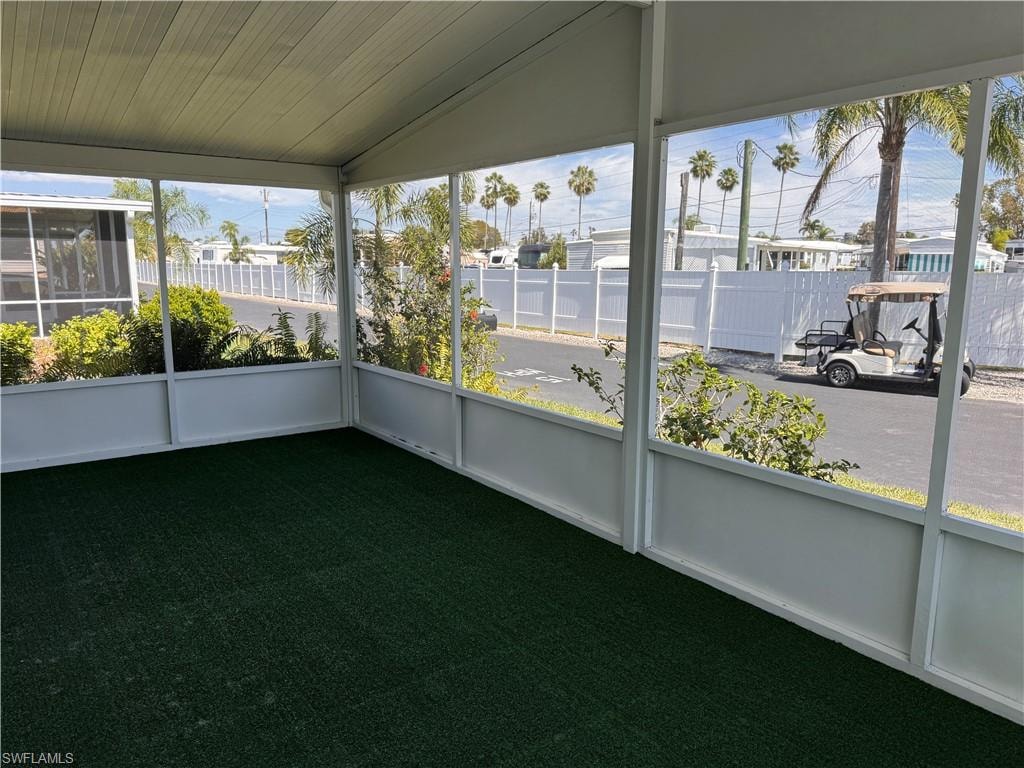 Unfurnished sunroom with vaulted ceiling