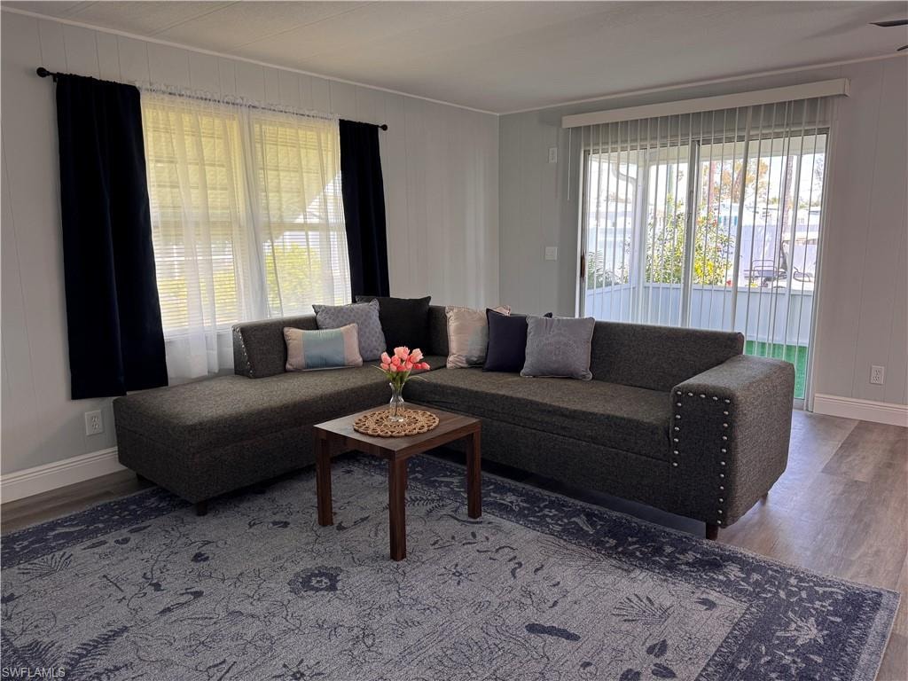 Living room with laminate flooring, slider access to front sunroom