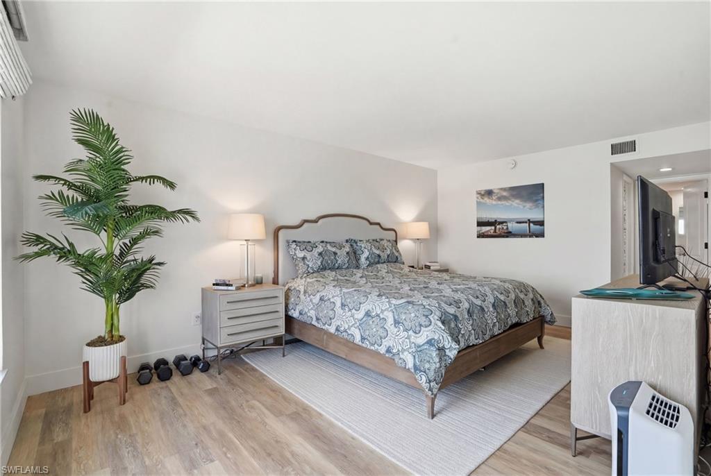 Bedroom featuring light wood finished floors and baseboards - Virtually Edited Image