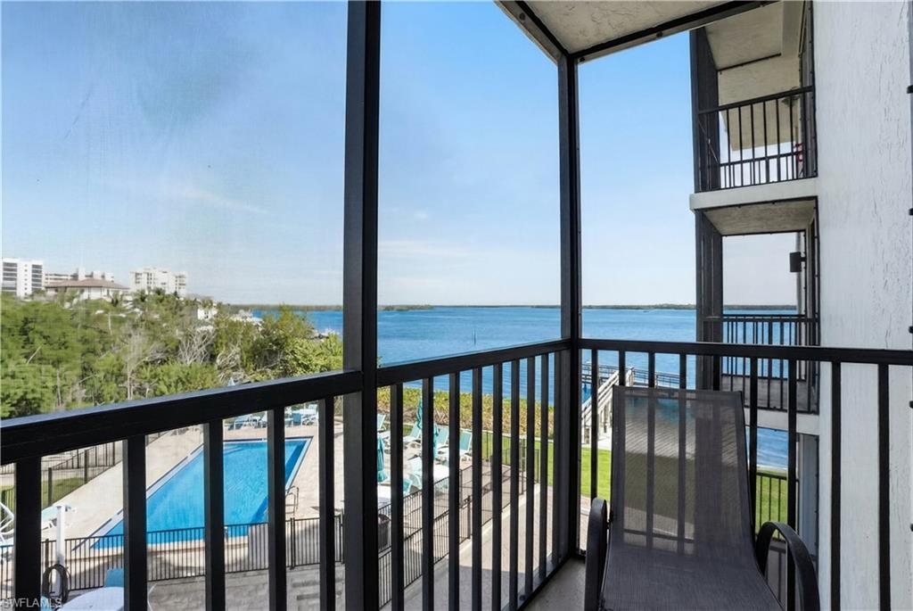 Side Balcony off of Dining Area featuring view of pool, and view of San Carlos Pass - Virtually Edited Image