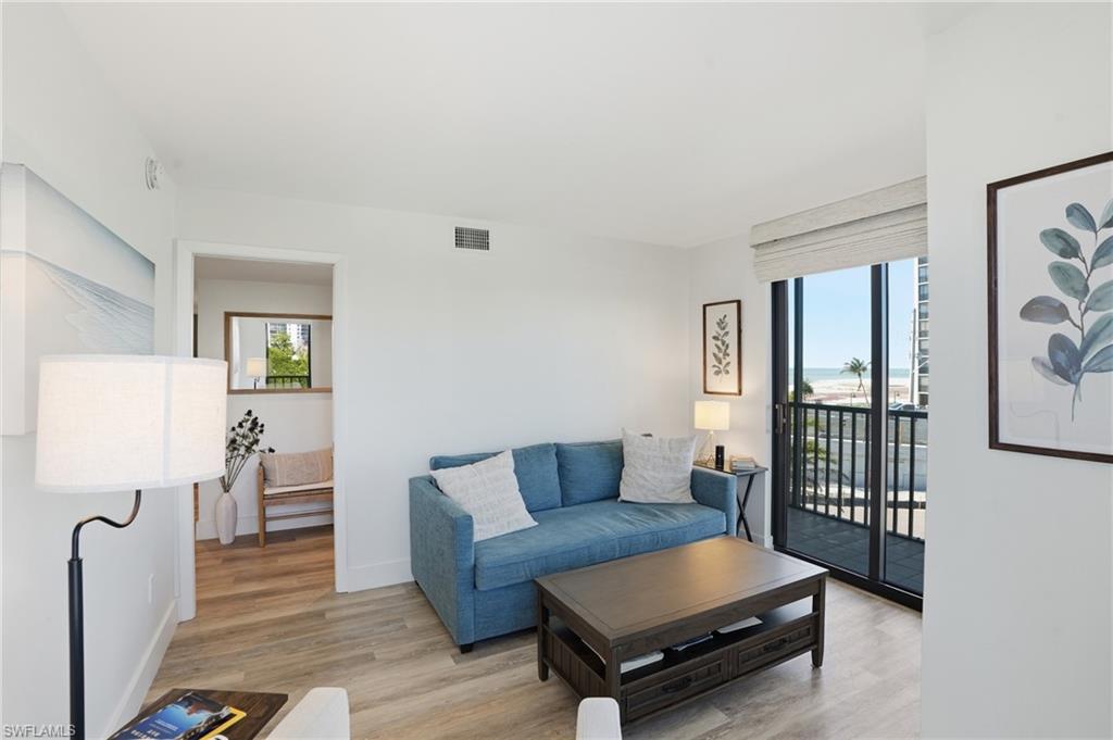 Guest room #3 with the same  light wood-style floors and baseboards throughout - Virtually Edited Image