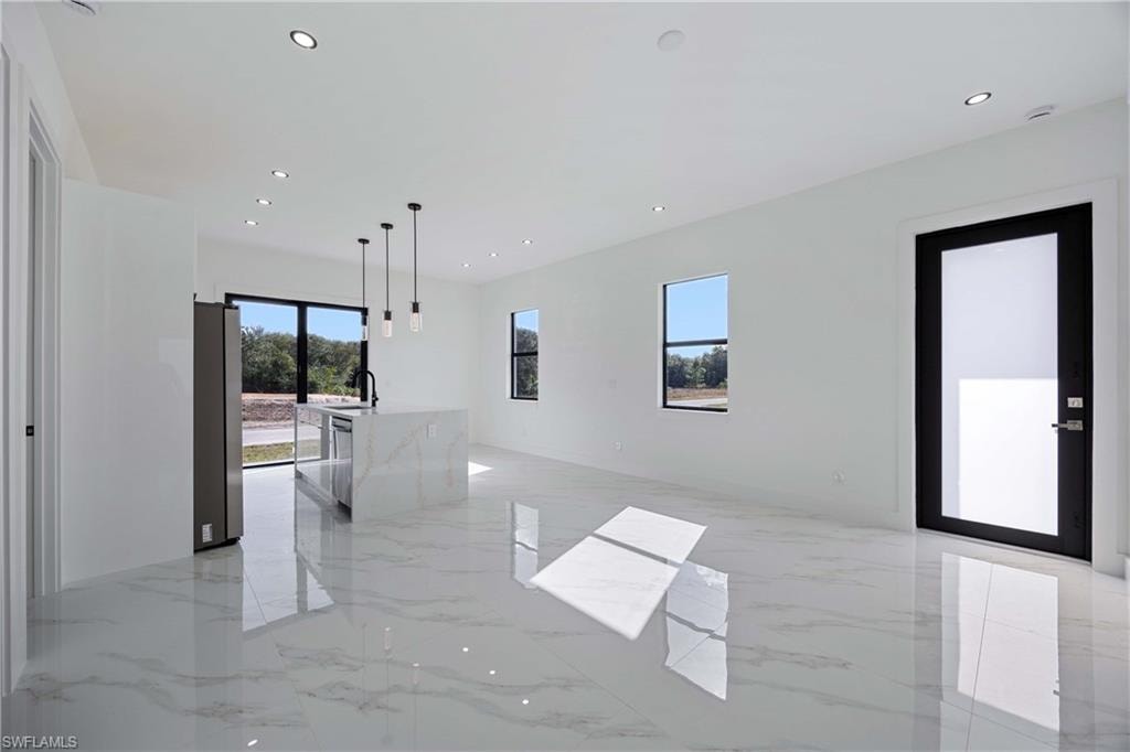 Unfurnished room with recessed lighting and light marble finish flooring