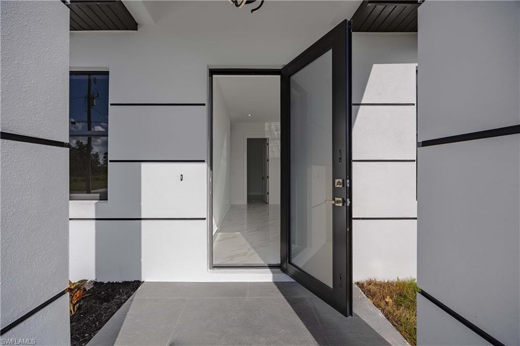 Entrance to property with stucco siding