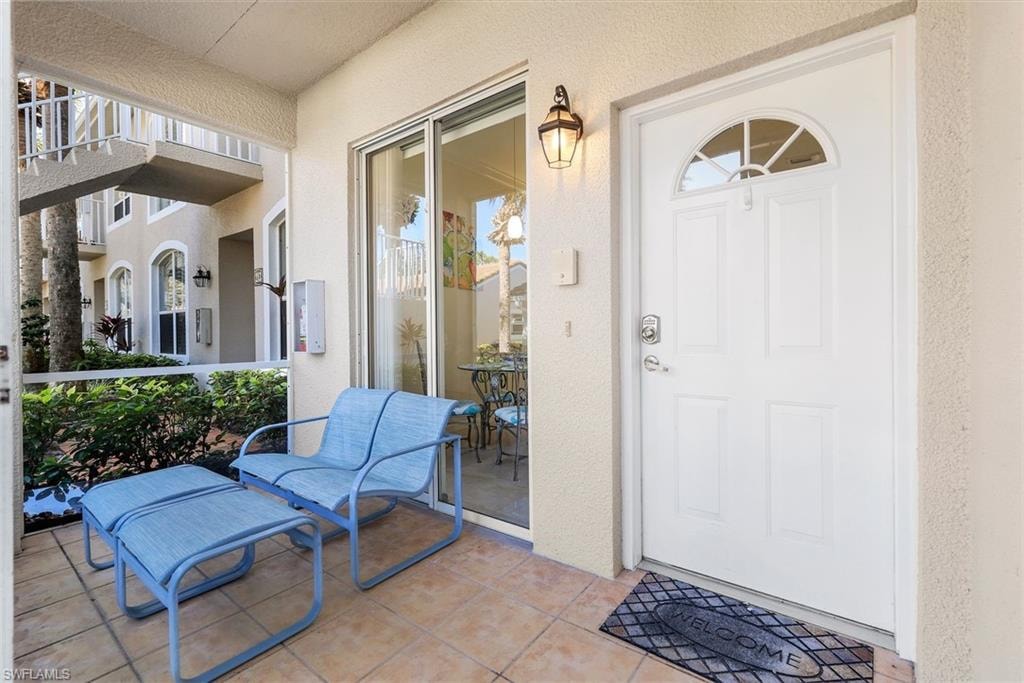 View of front screened in lanai with glass sliding doors which allows for refreshing cross breezes.