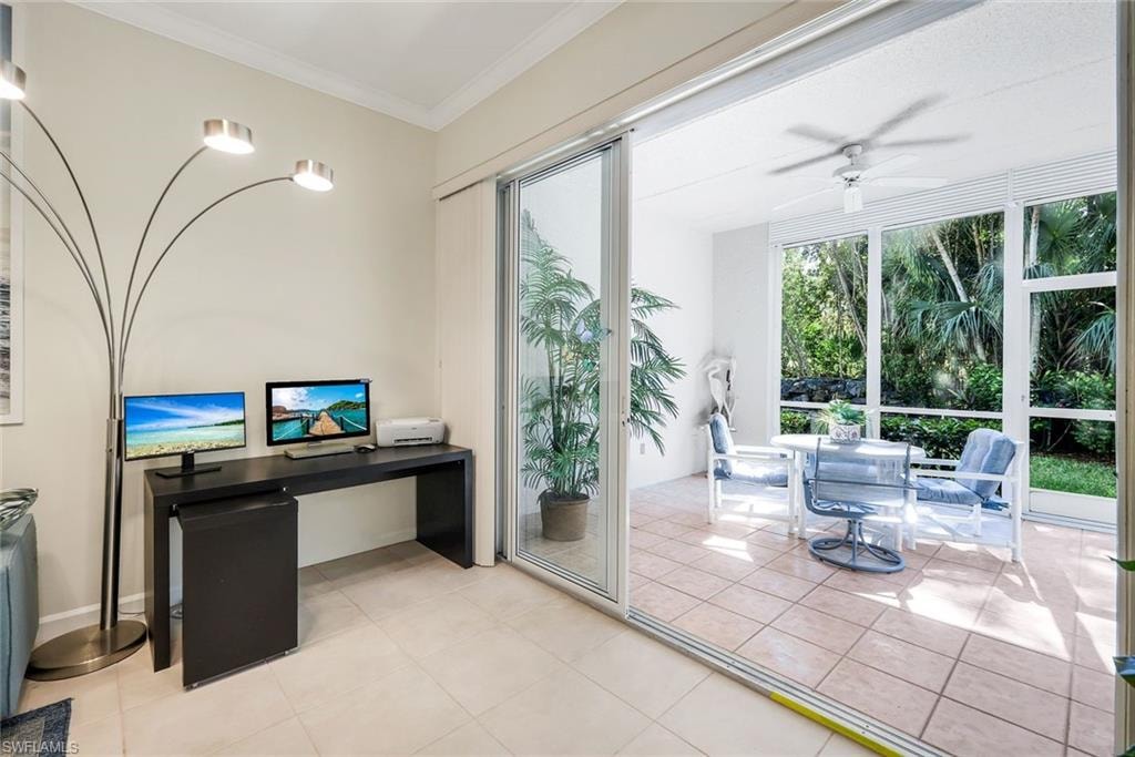 Home office work area light tile patterned floors, crown molding and rear sliders leading into the rear Lanai.