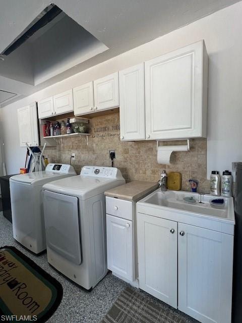 Laundry area with washer and clothes dryer, cabinet space, and dark speckled floor