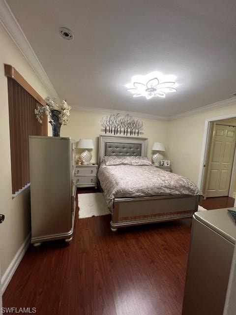 Bedroom featuring crown molding and dark wood-type flooring