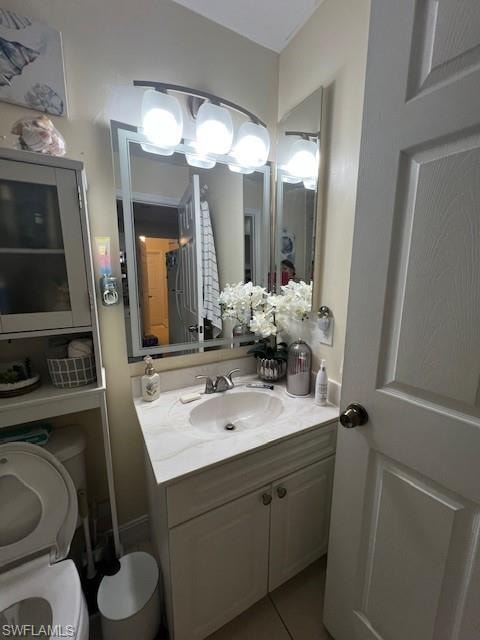 Half bath featuring vanity and light tile patterned floors