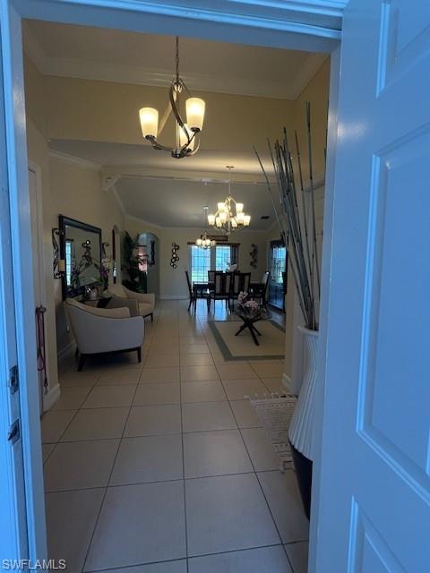 Hall with suspended lighting, light tile patterned floors, lofted ceiling, and crown molding