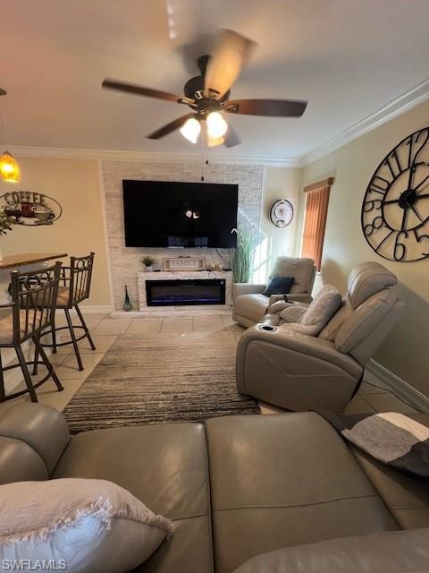 Living area with light tile patterned floors, crown molding, a ceiling fan, and a fireplace