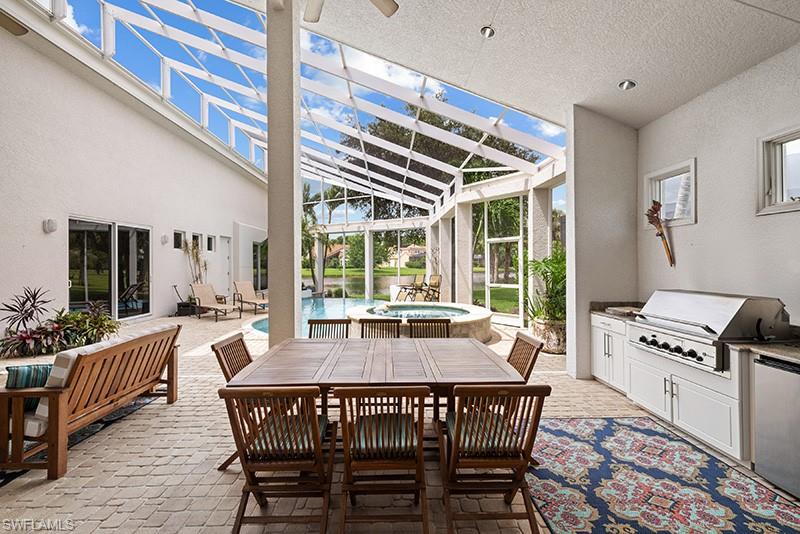 Lanai view with built in kitchen and teak furniture