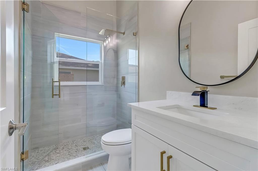 Bathroom featuring vanity and a shower stall