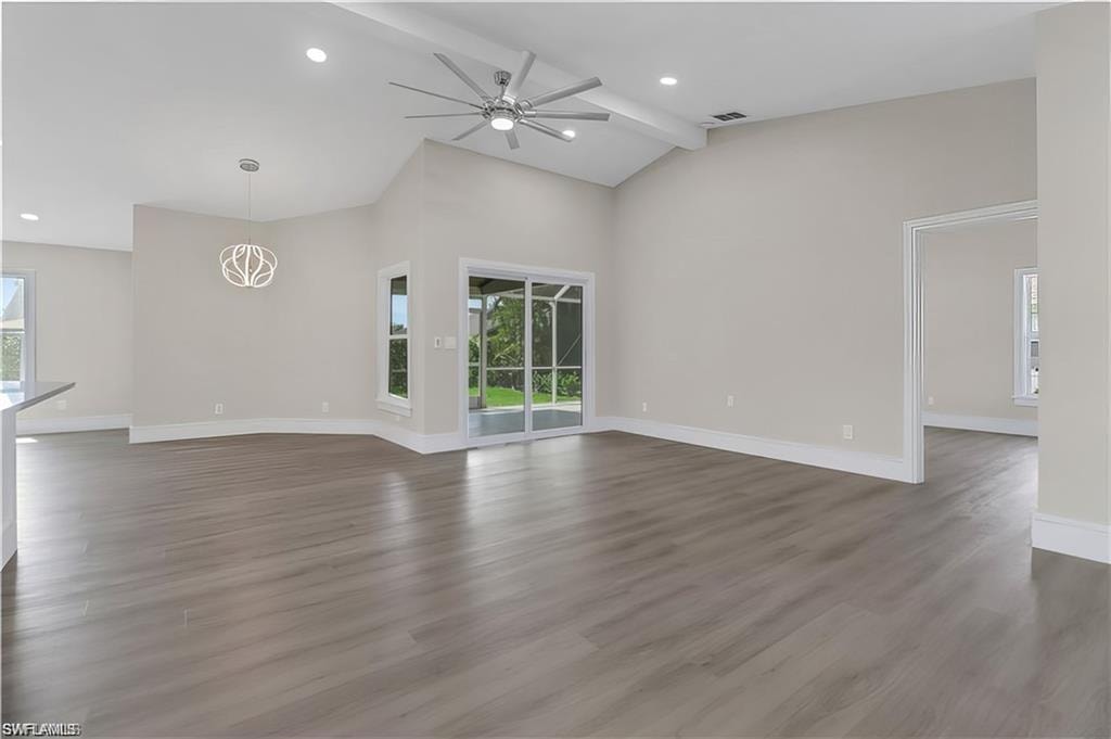 Unfurnished living room featuring ceiling fan, dark wood-type flooring, vaulted ceiling, and recessed lighting