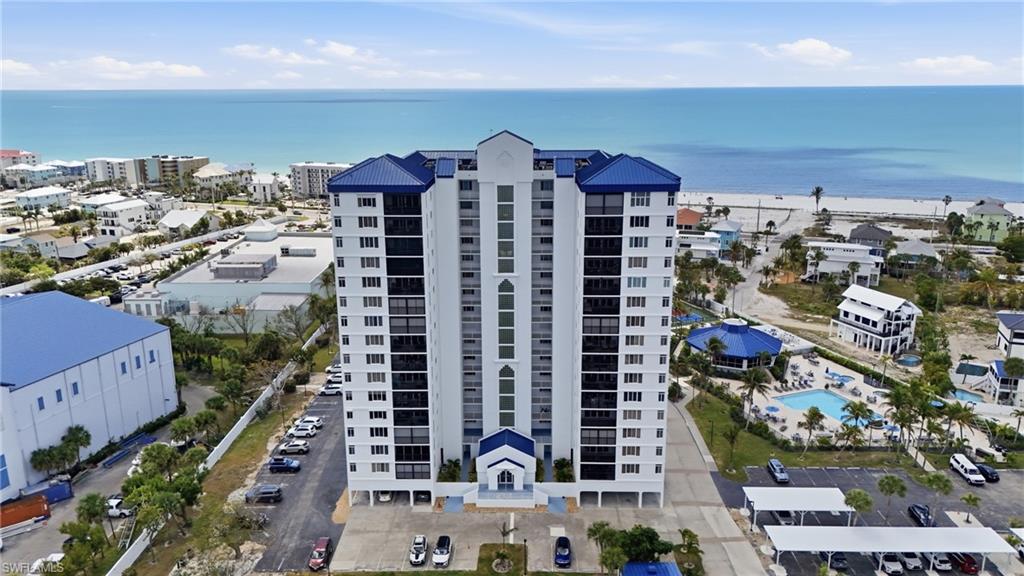 Drone / aerial view of apartment complex and a large body of water - Virtually Edited Image