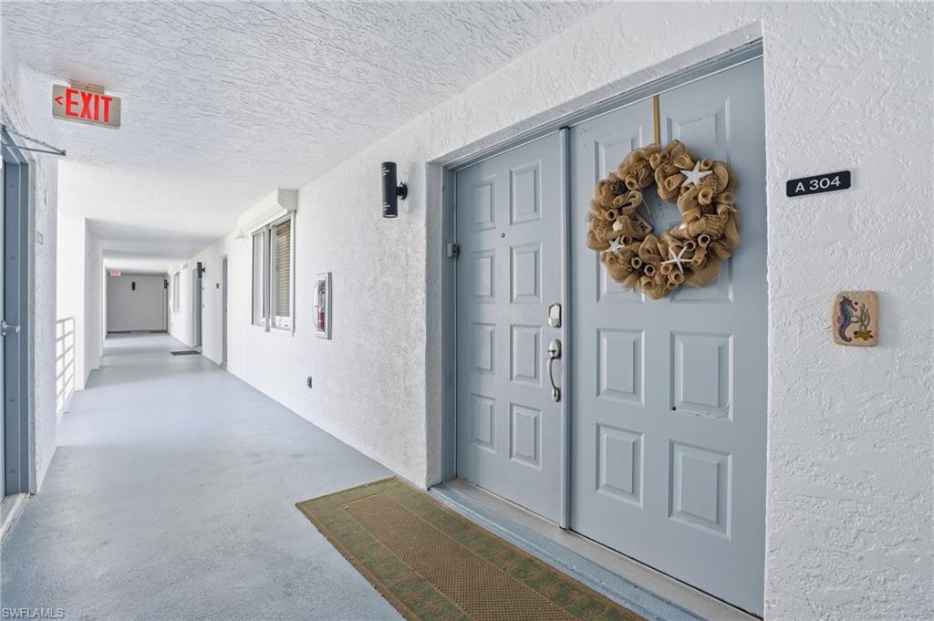 View of exterior entry featuring stucco siding - Virtually Edited Image