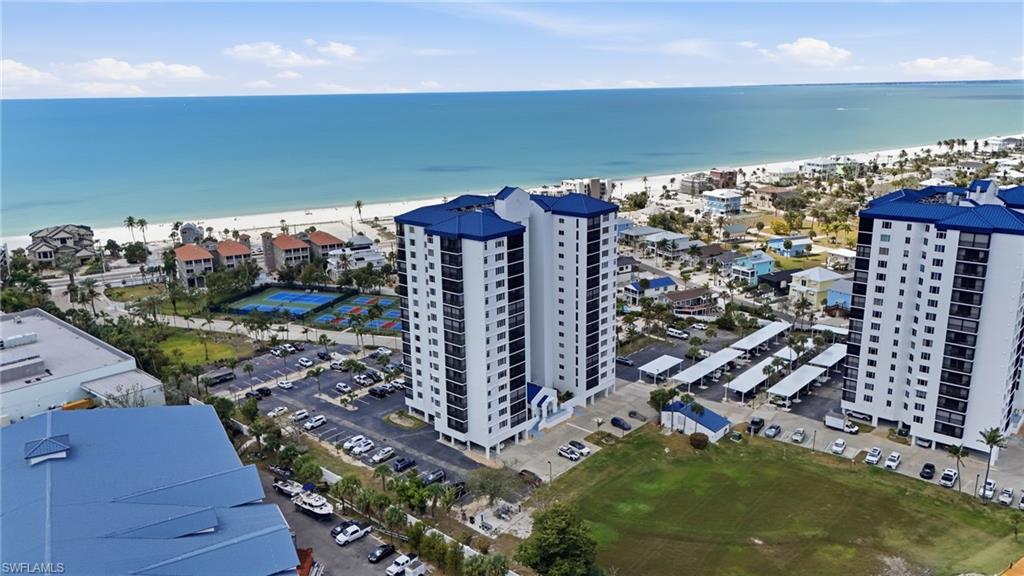Aerial view of waterfront with a beach and apartment complex - Virtually Edited Image