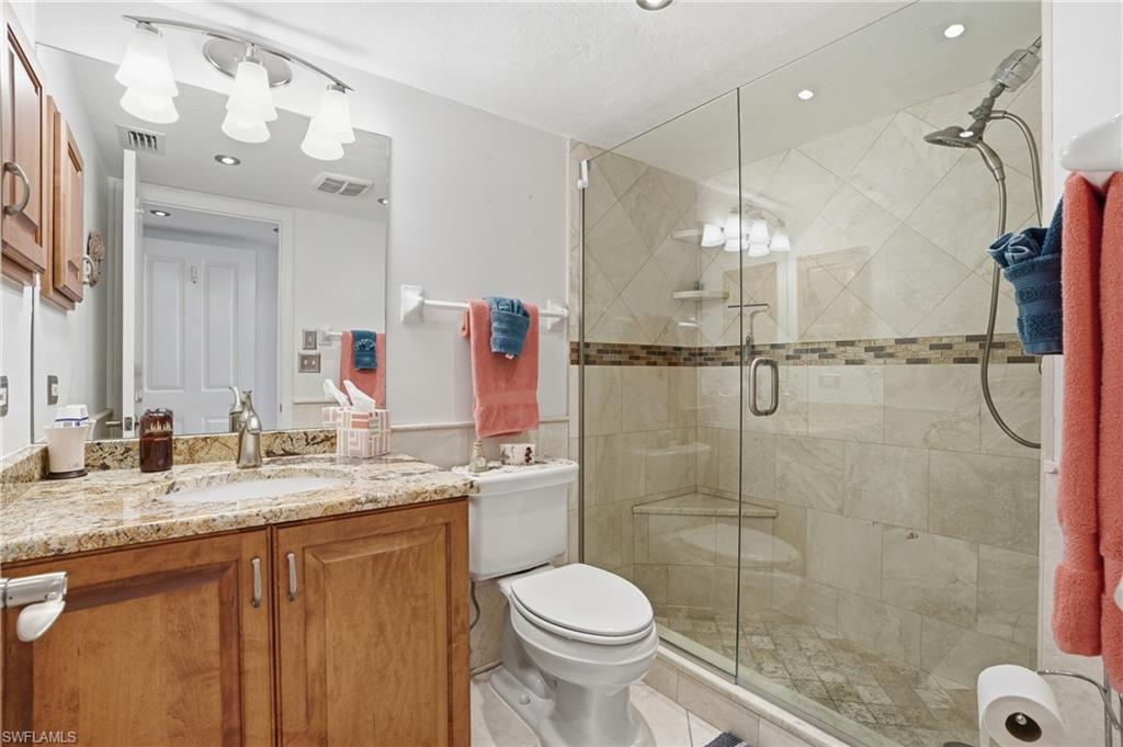 Bathroom with vanity, a shower stall, wainscoting, and recessed lighting - Virtually Edited Image