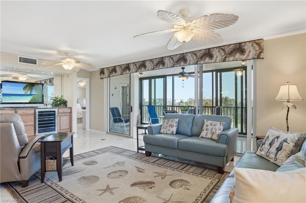 Living area with ornamental molding and wine cooler - Virtually Edited Image