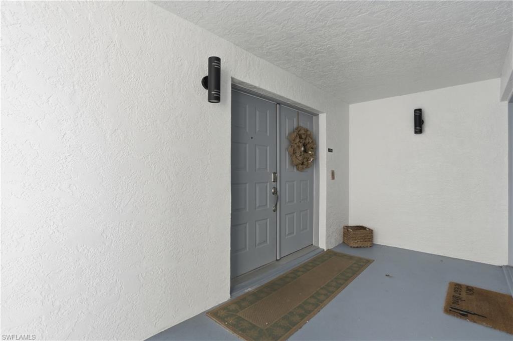 Property entrance featuring stucco siding - Virtually Edited Image