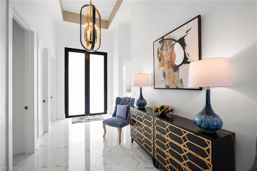 Entryway featuring french doors and an inviting chandelier
