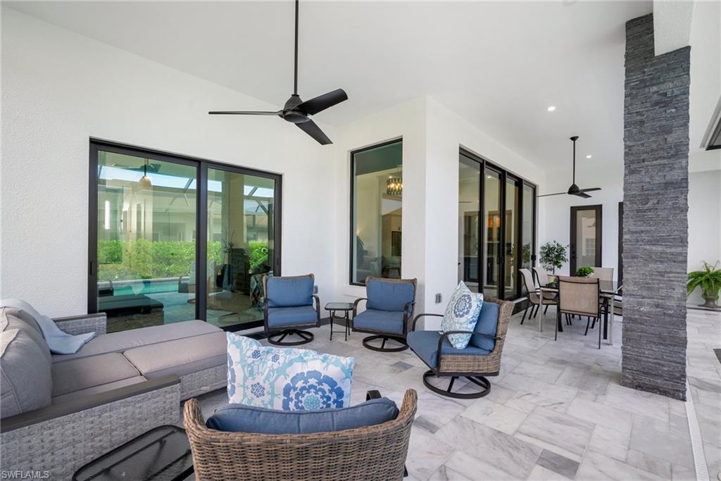 View of patio with an outdoor living space and ceiling fan