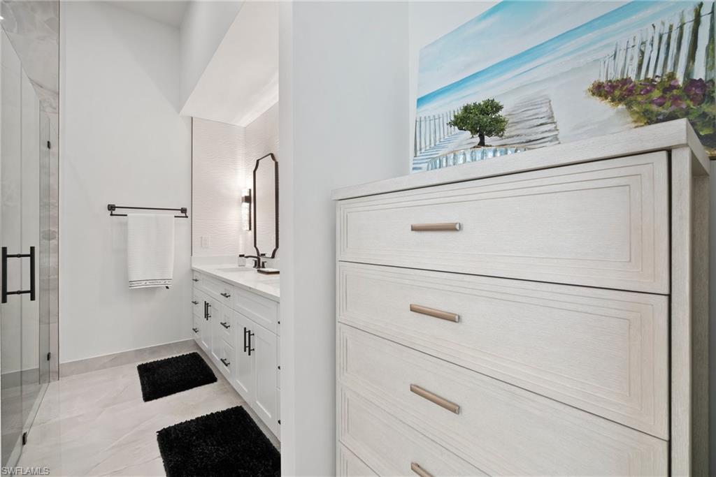 Bathroom featuring vanity and a shower with door