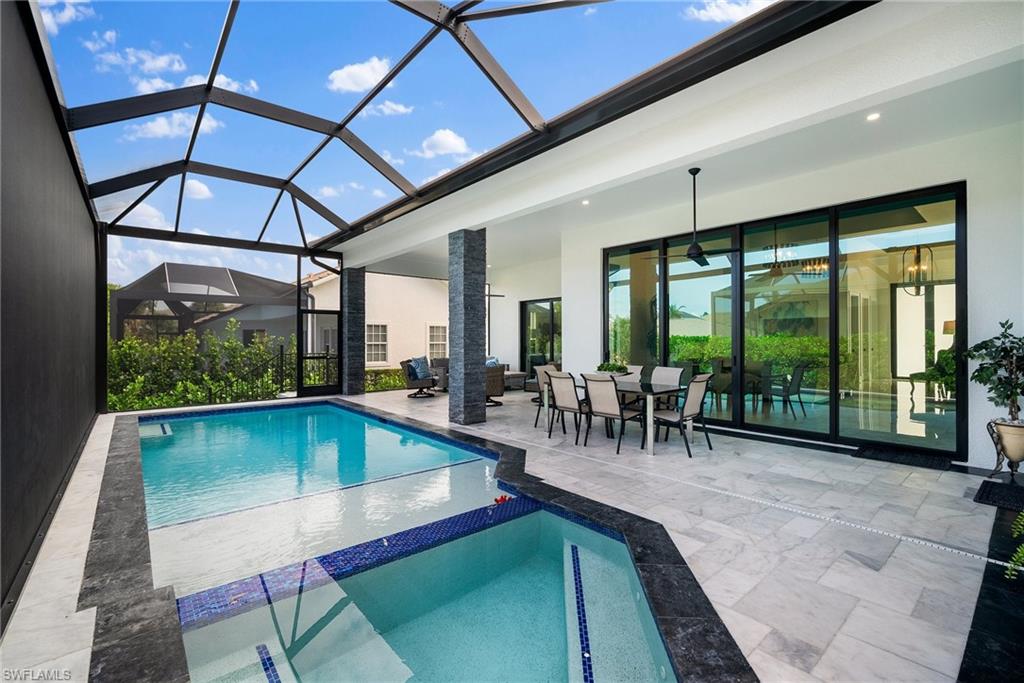 View of pool featuring a lanai, a patio area, and ceiling fan