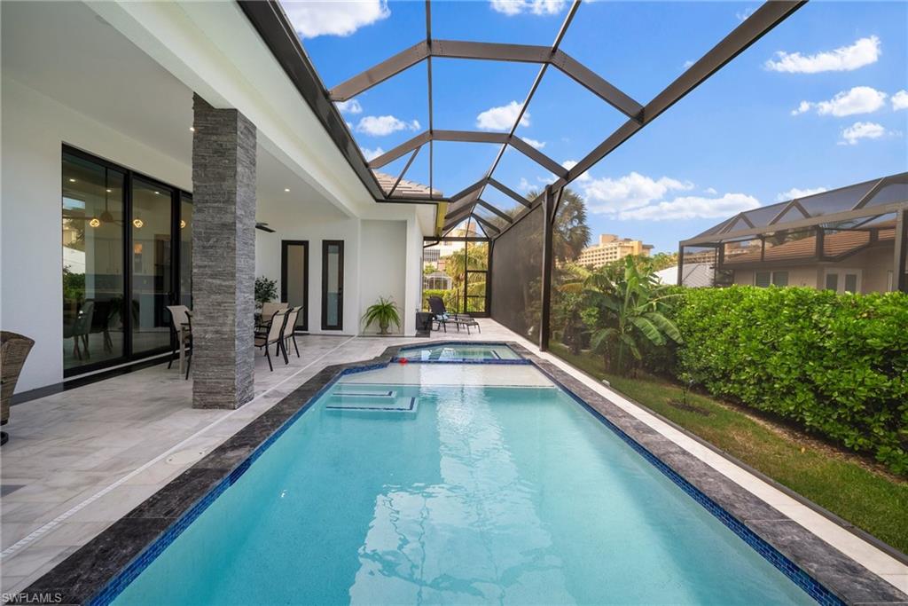 View of swimming pool featuring a lanai and a patio area