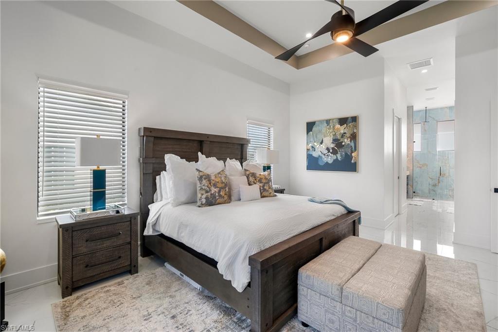 Bedroom featuring ceiling fan and ensuite bathroom