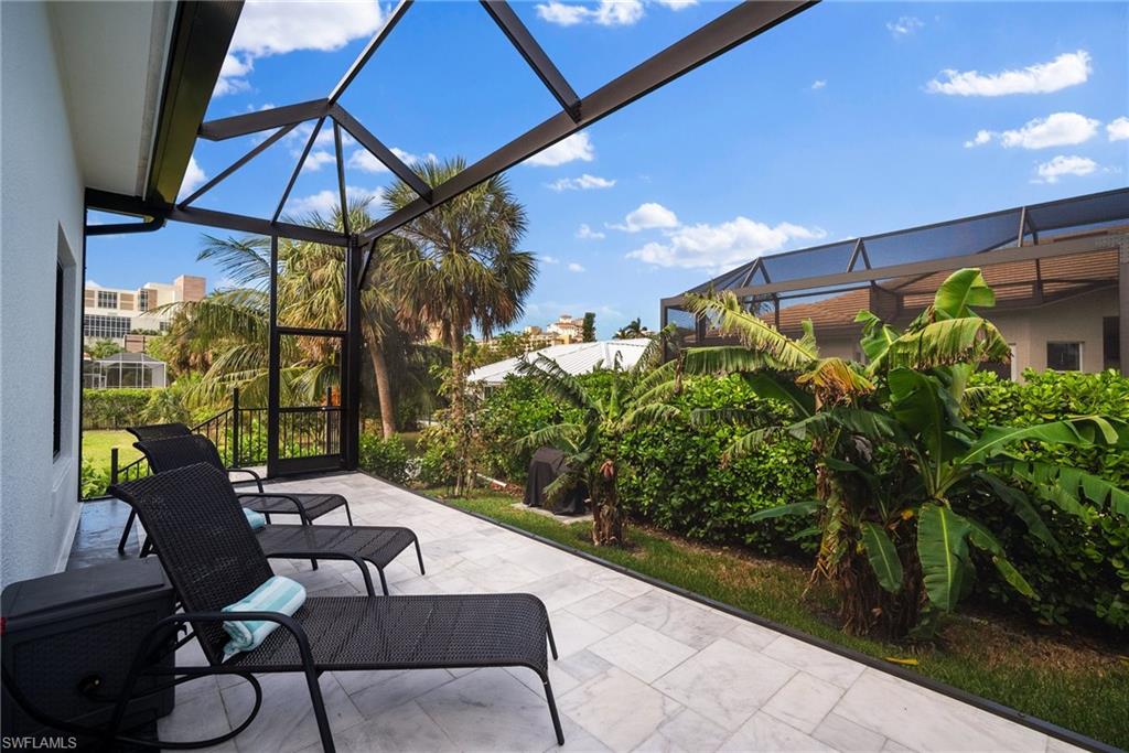 View of patio featuring glass enclosure