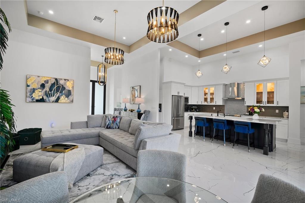 Living room with a high ceiling and a chandelier